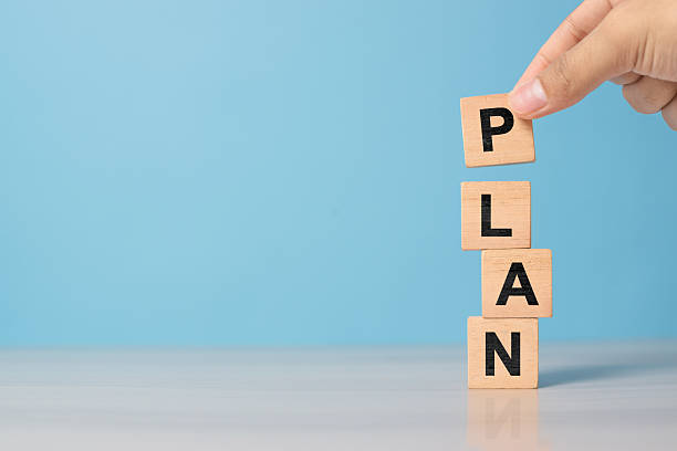 istock Hand presents PLAN block on neutral background. Concept for roadmap, productivity, and planning success in business. 2220810570