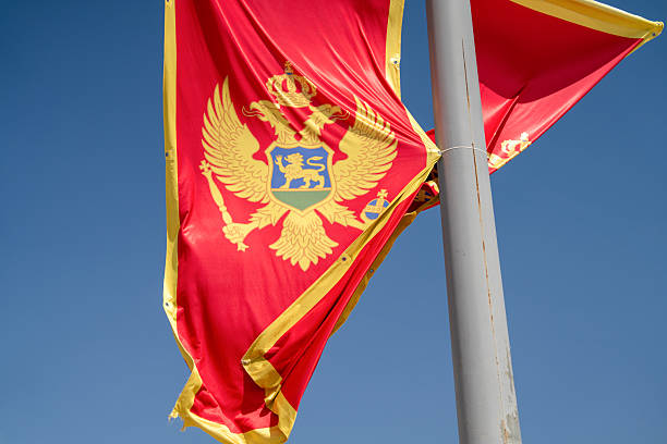 istock Montenegro national flag waving against clear blue sky 2220812261