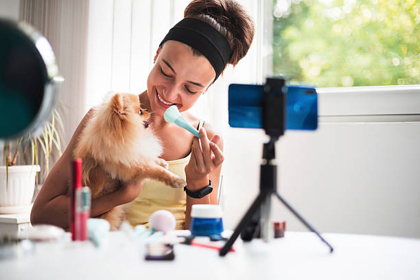 istock Beauty vlogger films with her dog during a makeup session 2220814243
