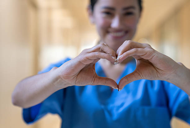 istock Portrait of a nurse making a heart shape with her hands 2220814593