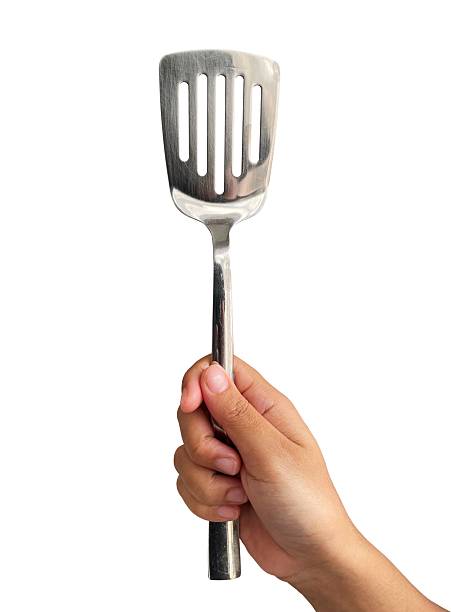 istock hand holding stainless steel spatula 2220819784