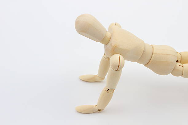 istock Wooden mannequin push-up, concentrated posture. 2220827254