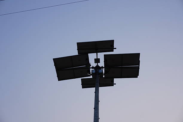 istock Solar-powered street light or floodlight system, identifiable by the multiple solar panels attached to the pole 2220833062