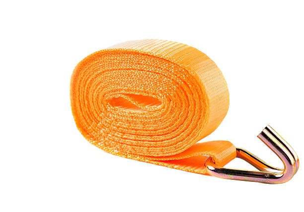 istock Orange lashing strap with metal ratchet and hook, displayed on clean white background. Used for securing cargo during transport. 2220833598