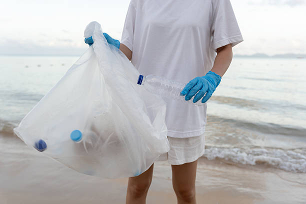 istock Save ocean. Volunteer pick up trash garbage at the beach and plastic bottles are difficult decompose prevent harm aquatic life. Earth, Environment, Greening planet, reduce global warming, Save world 2220833755