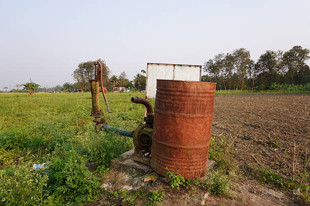 A primitive, makeshift irrigation system in a rural agricultural setting using for watering to field