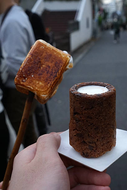Close up fresh milk in cocoa shot and S'more pop stick