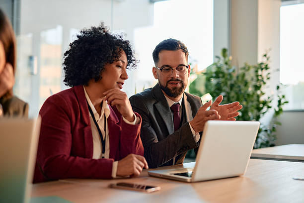 istock Business partners discussing work using laptop in modern office 2220839925