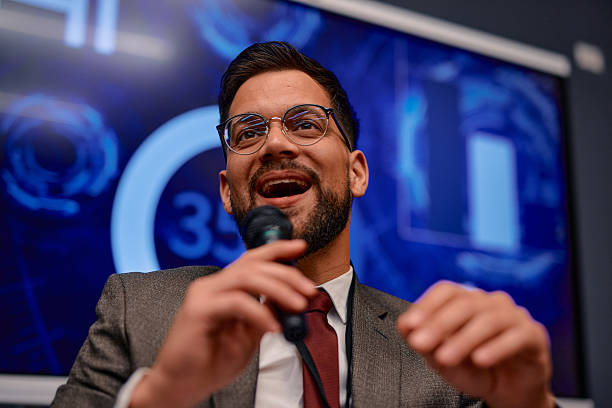 istock Motivational speaker inspiring audience with his speech during a business conference 2220840308