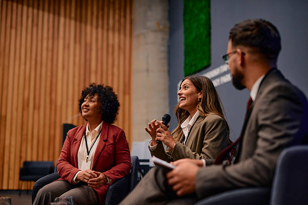 istock Businesswomen speaking at a conference using a microphone 2220840313