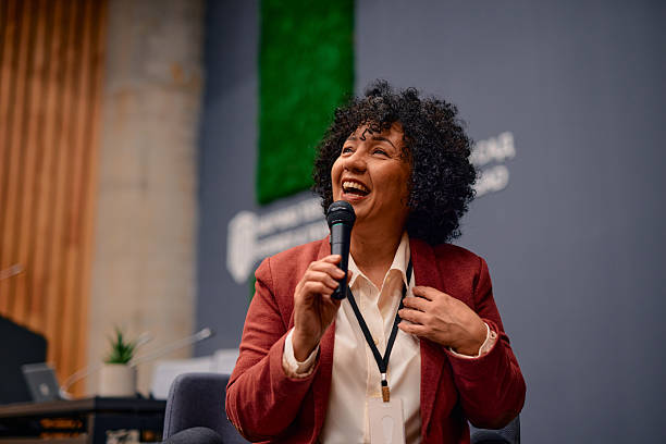 istock Motivational speaker inspiring audience with her speech during a conference 2220840519