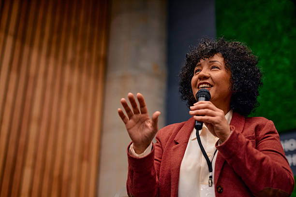 istock Motivational speaker inspiring audience with her speech during a conference 2220840606