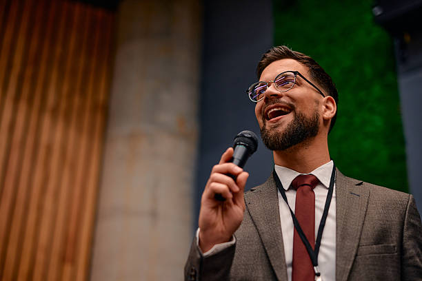 istock Motivational speaker inspiring audience with his speech during business conference 2220840612