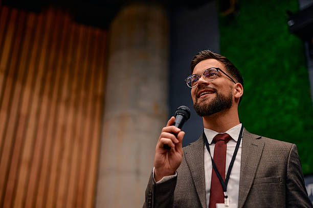 istock Motivational speaker inspiring audience with his speech during business conference 2220840637