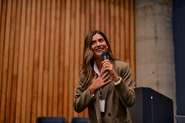 Businesswoman expressing gratitude while speaking at a conference