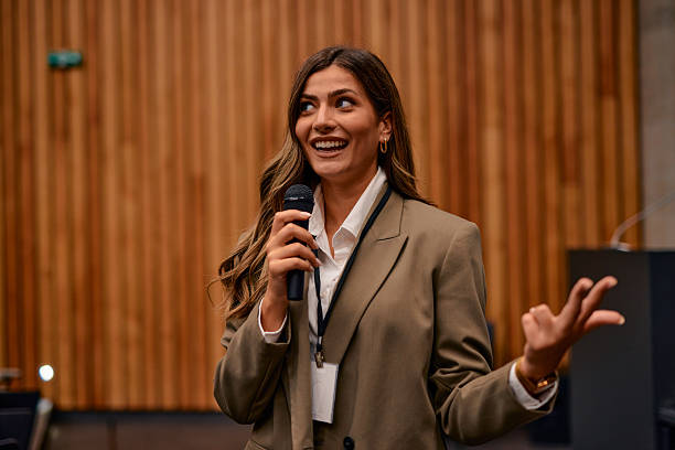 istock Young businesswoman speaking at a conference using a microphone 2220840664