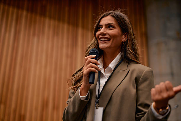 istock Young businesswoman speaking at a conference using a microphone 2220840666
