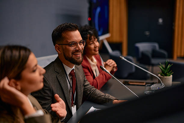 Politicians smiling and speaking during a press conference