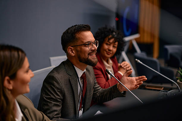 istock Politician speaking at a press conference, gesturing with his hand 2220840684