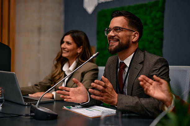 istock Businessman Clapping and Smiling at Conference Table During a Meeting 2220841168