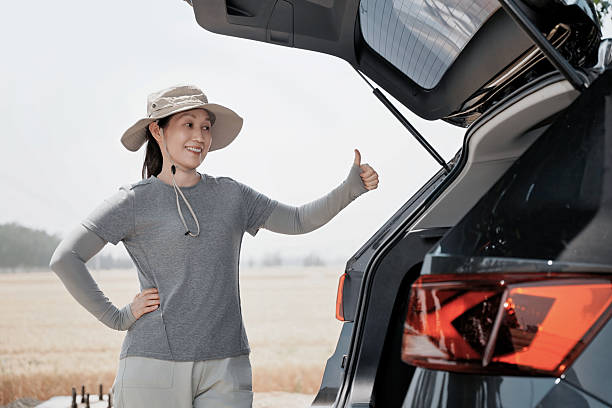 istock Woman Checking Car Trunk Open Successfully 2220841172