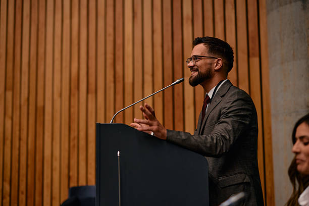 istock Motivational speaker inspiring audience with his speech at conference 2220841181