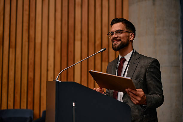 istock Motivational speaker inspiring audience with his speech at conference 2220841182
