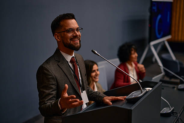 istock Motivational speaker inspiring audience with engaging speech at conference 2220841193