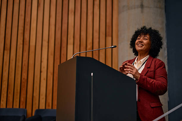 istock Motivational speaker inspiring audience with her speech at conference 2220841209