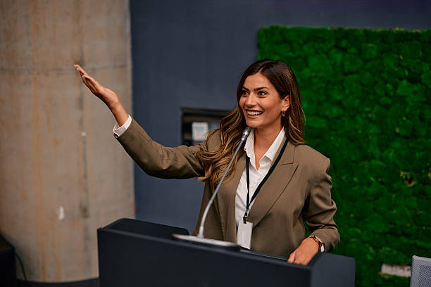 istock Businesswoman gesturing while giving a speech at a conference 2220841225