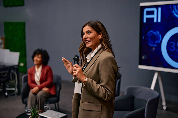 istock Smiling businesswoman speaking at a corporate event about artificial intelligence 2220841261