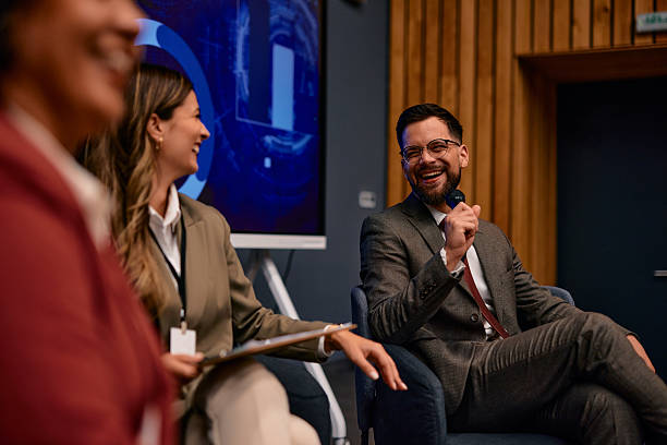 istock Happy businessman laughing while speaking at a conference 2220841406