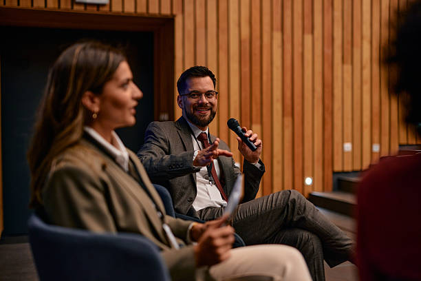 istock Businessman talking on stage during a conference in a modern auditorium 2220841410