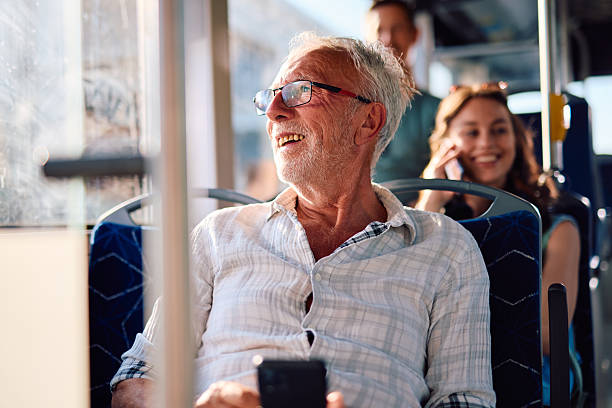 istock Senior man enjoying a bus ride looking out the window 2220842523