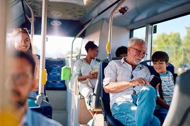 istock Grandfather and grandson using tablet on the bus during their trip 2220842538