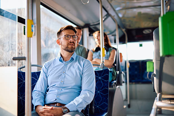 istock Young businessman commuting by bus looking out window 2220842551
