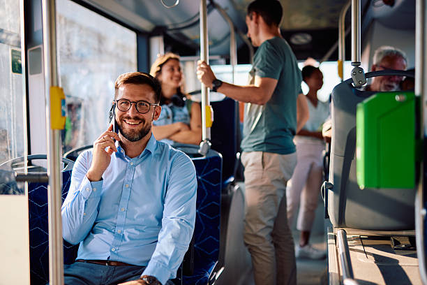 istock Young businessman talking on the phone while commuting by bus 2220842563