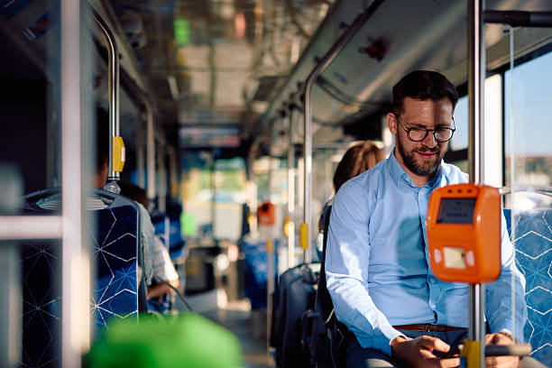 istock Young businessman paying for bus ticket with smartphone NFC technology 2220842705