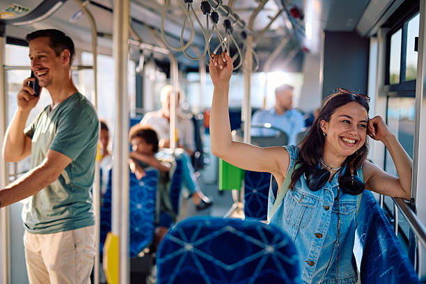 istock Young woman commuting by bus, holding the handle and smiling 2220842829