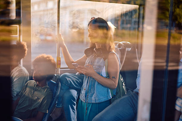 istock Young woman using smartphone while traveling by bus 2220842935