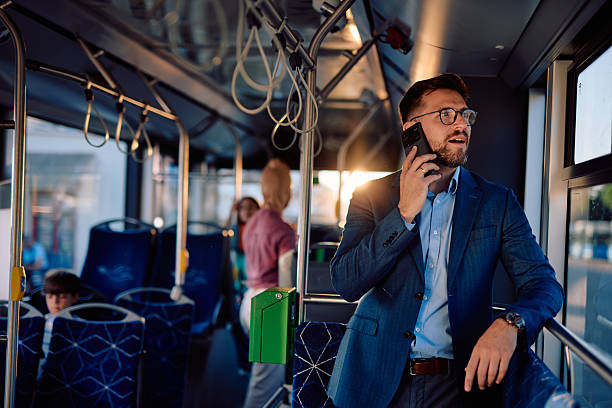 istock Businessman talking on the phone while commuting by bus 2220843056