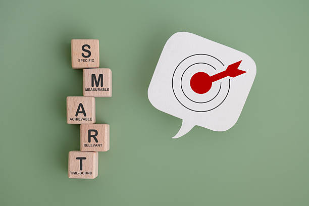 istock Smart goal for business strategy concept. SMART for specific, measurable, achievable, relevant and time-bound text on wooden block with dartboard on real speech bubble paper cut 2220843186