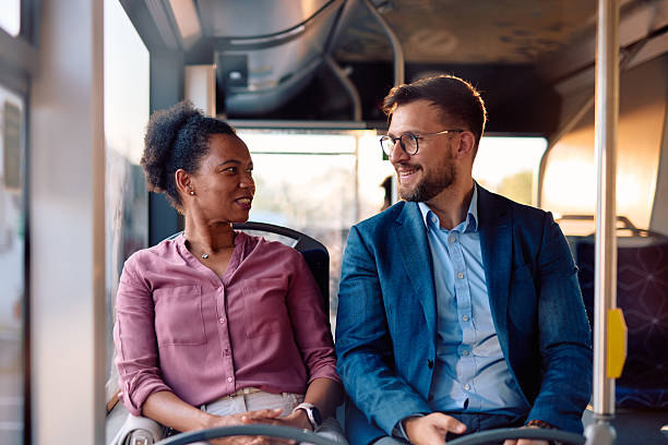 istock Business people commuting together and talking on the bus 2220843270