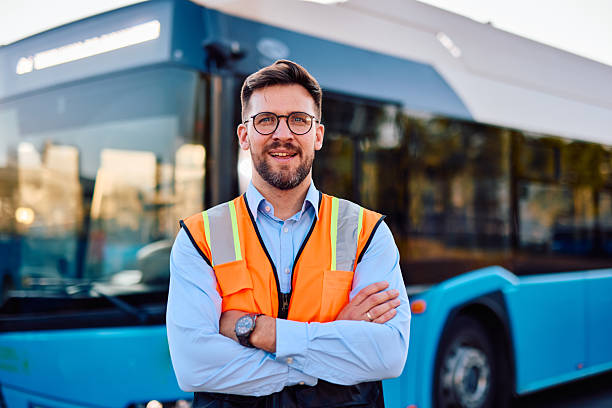 istock Engineer smiling with arms crossed in front of electric bus 2220843337