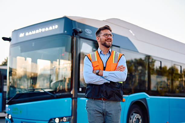 istock Engineer smiling with crossed arms in front of electric bus 2220843345