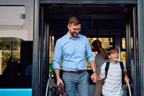 istock Father and son exiting the bus holding hands after their daily commute 2220843385