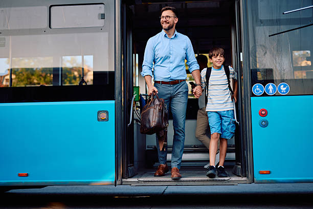 Father and son leaving public transport, holding hands and smiling, sharing a joyful moment together while enjoying their city adventure on a sunny day