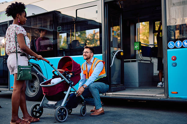 istock Bus driver helping a mother with a stroller to board the bus 2220843419