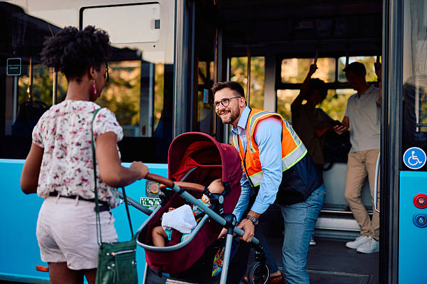 istock Bus driver helping young mother boarding a bus with a stroller 2220843422