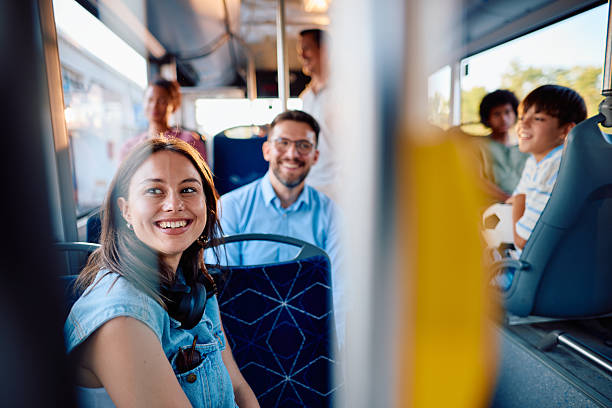 istock Happy passengers smiling while traveling on a public transport bus 2220843483